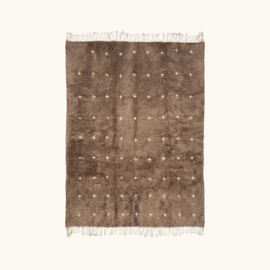 Full view of the Targa taupe Beni Ourain rug with small ivory cross motifs.