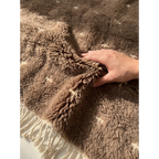 Plush natural wool pile detail of the Targa taupe Beni Ourain rug.