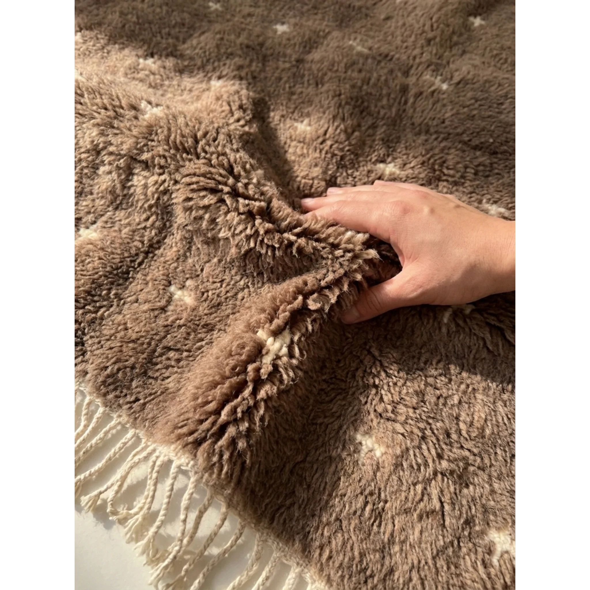 Plush natural wool pile detail of the Targa taupe Beni Ourain rug.