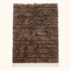 Taupe Beni Ourain rug with dense textured pile and ivory fringe, flat lay on neutral background