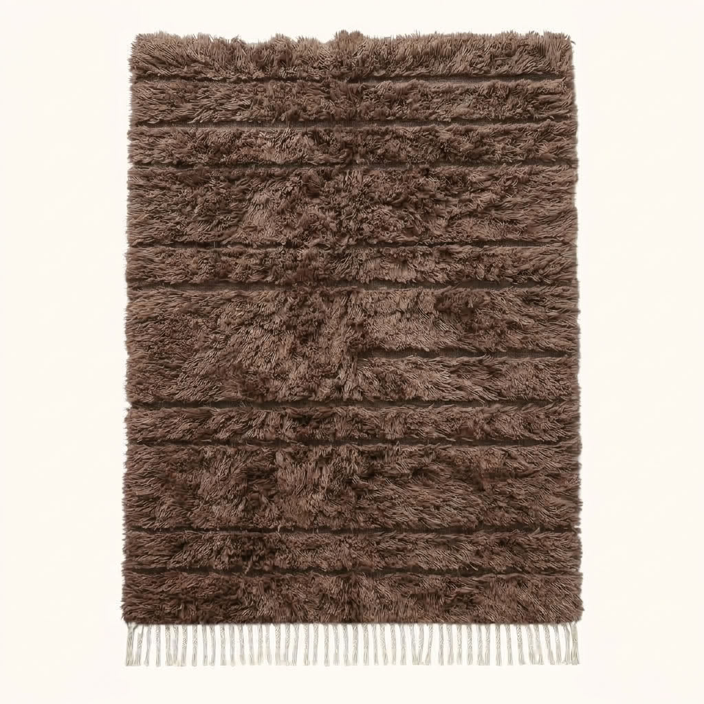 Taupe Beni Ourain rug with dense textured pile and ivory fringe, flat lay on neutral background