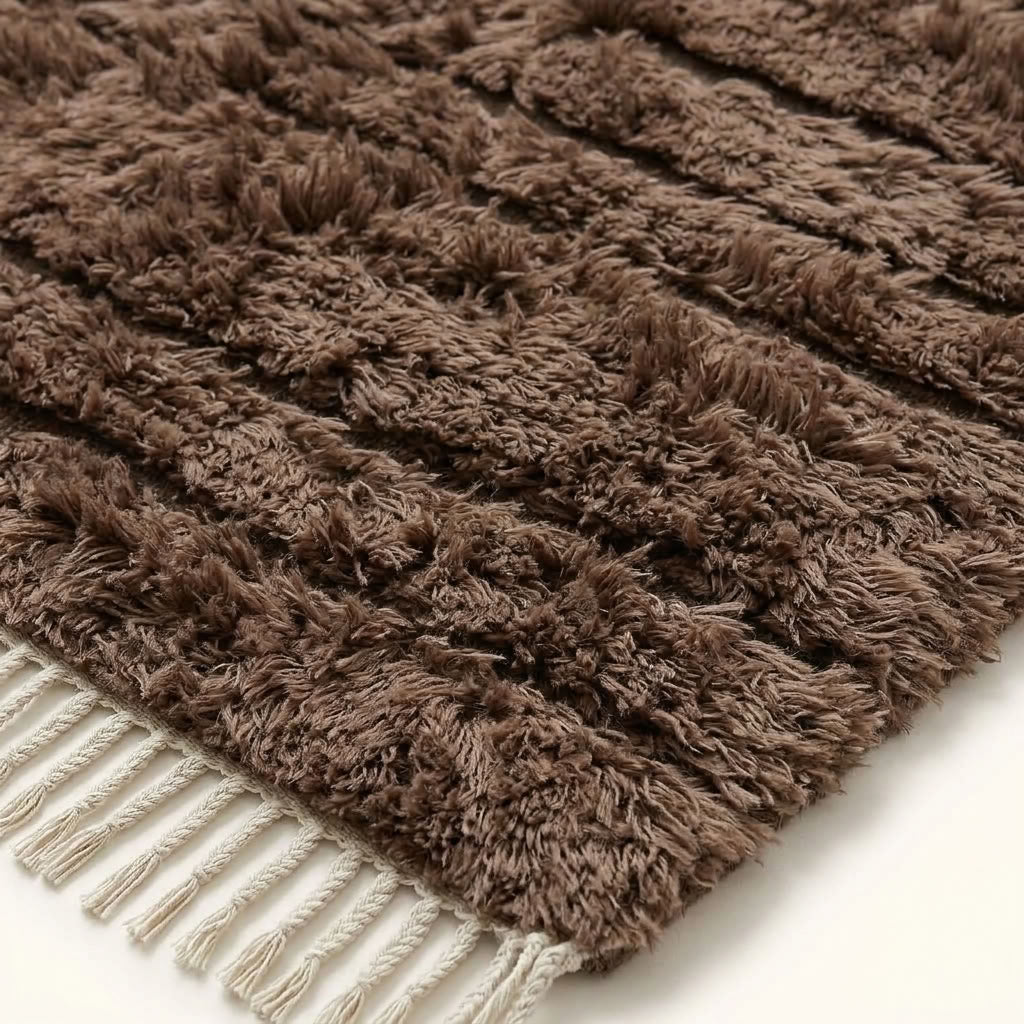 Extreme close-up of taupe Beni Ourain textured pile showing natural wool variation and knot structure