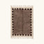 Full view of the Awrir taupe, brown and ivory Beni Ourain rug with a block border design.