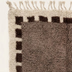 Angled view of the Awrir taupe, brown and ivory Beni Ourain rug.