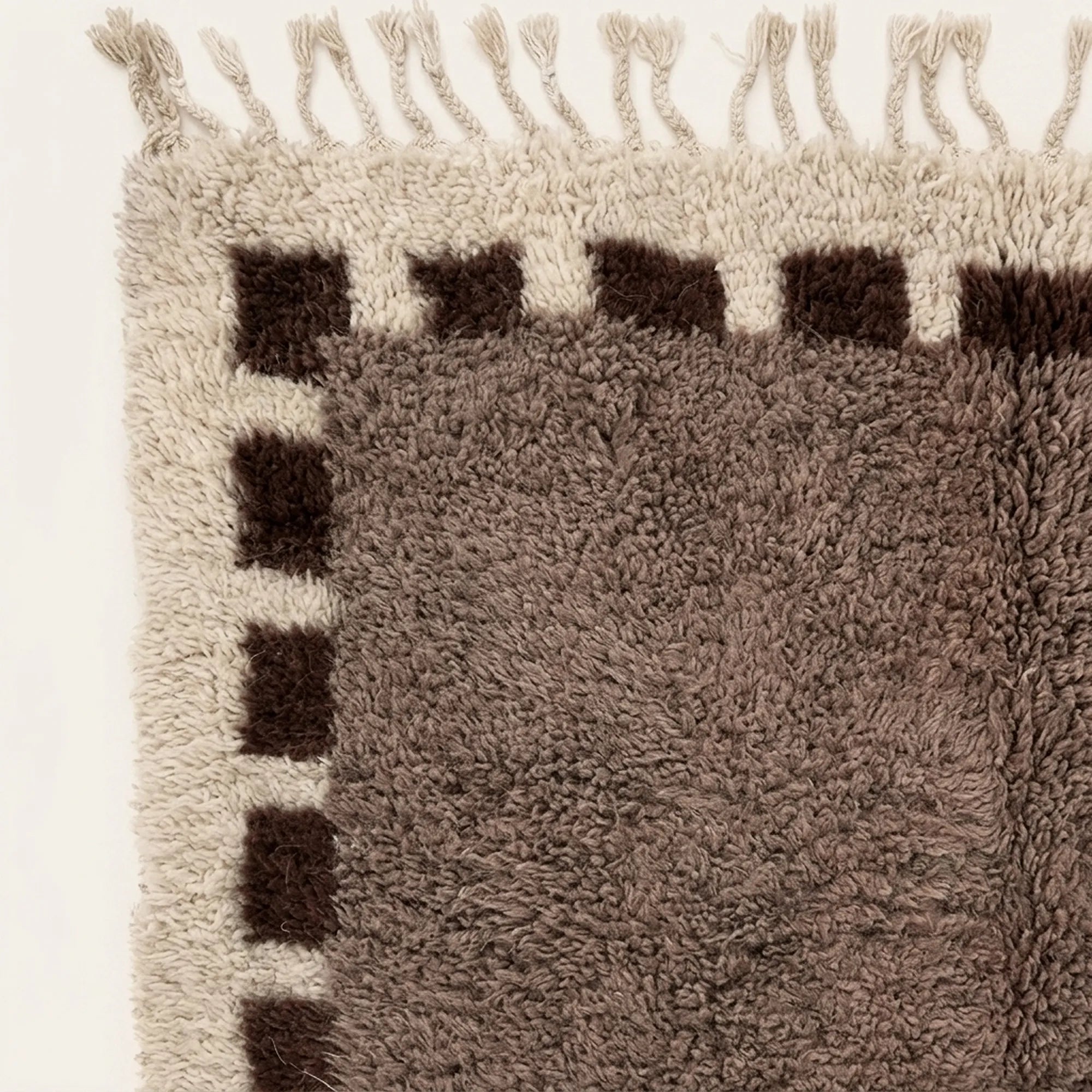 Angled view of the Awrir taupe, brown and ivory Beni Ourain rug.