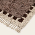 Fringe and edge detail of the Awrir taupe, brown and ivory Beni Ourain rug.