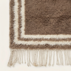 End view of the Ayyur Beni Ourain rug with its taupe field and ivory double border.