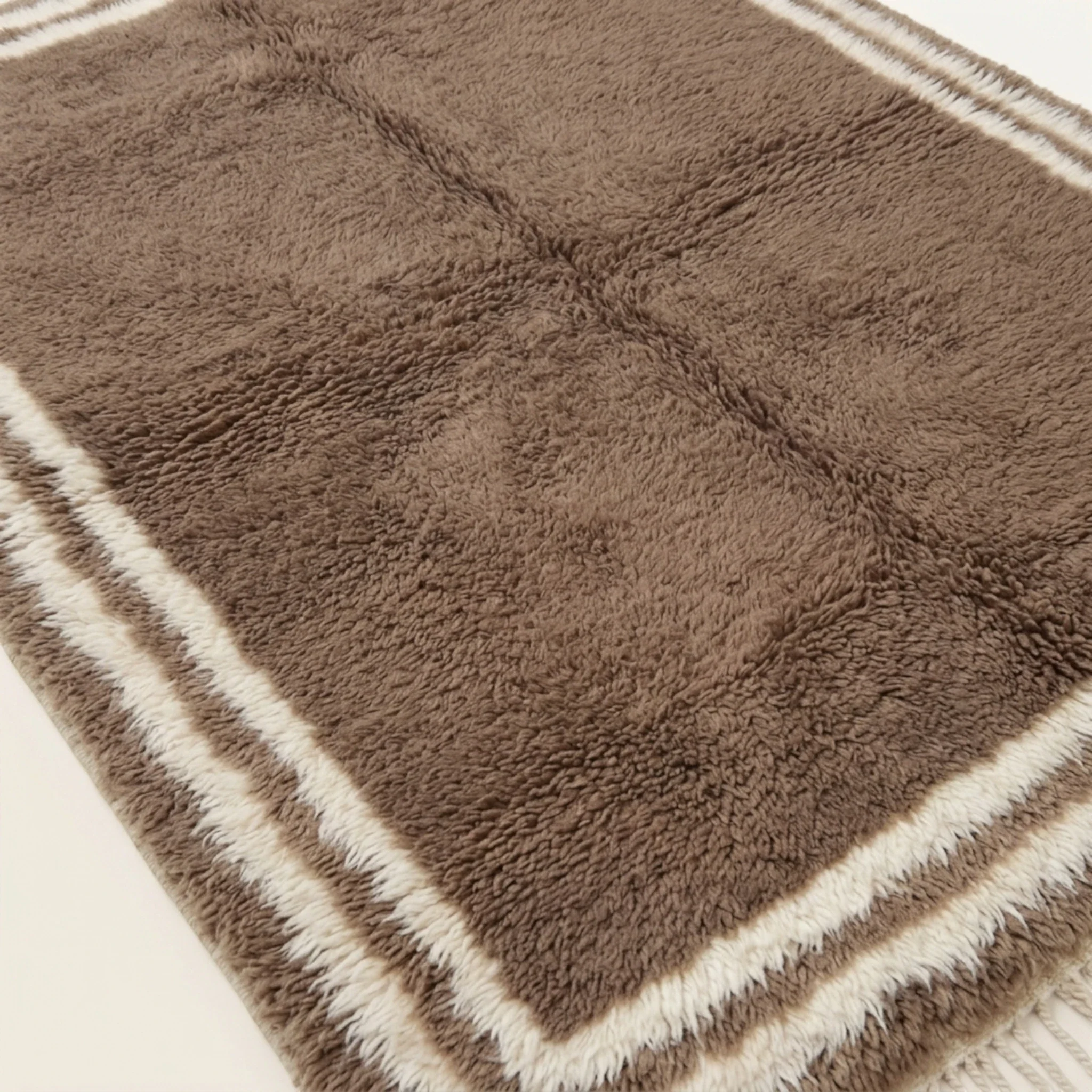 Dense natural Atlas wool pile texture of the Ayyur taupe and ivory Beni Ourain rug.