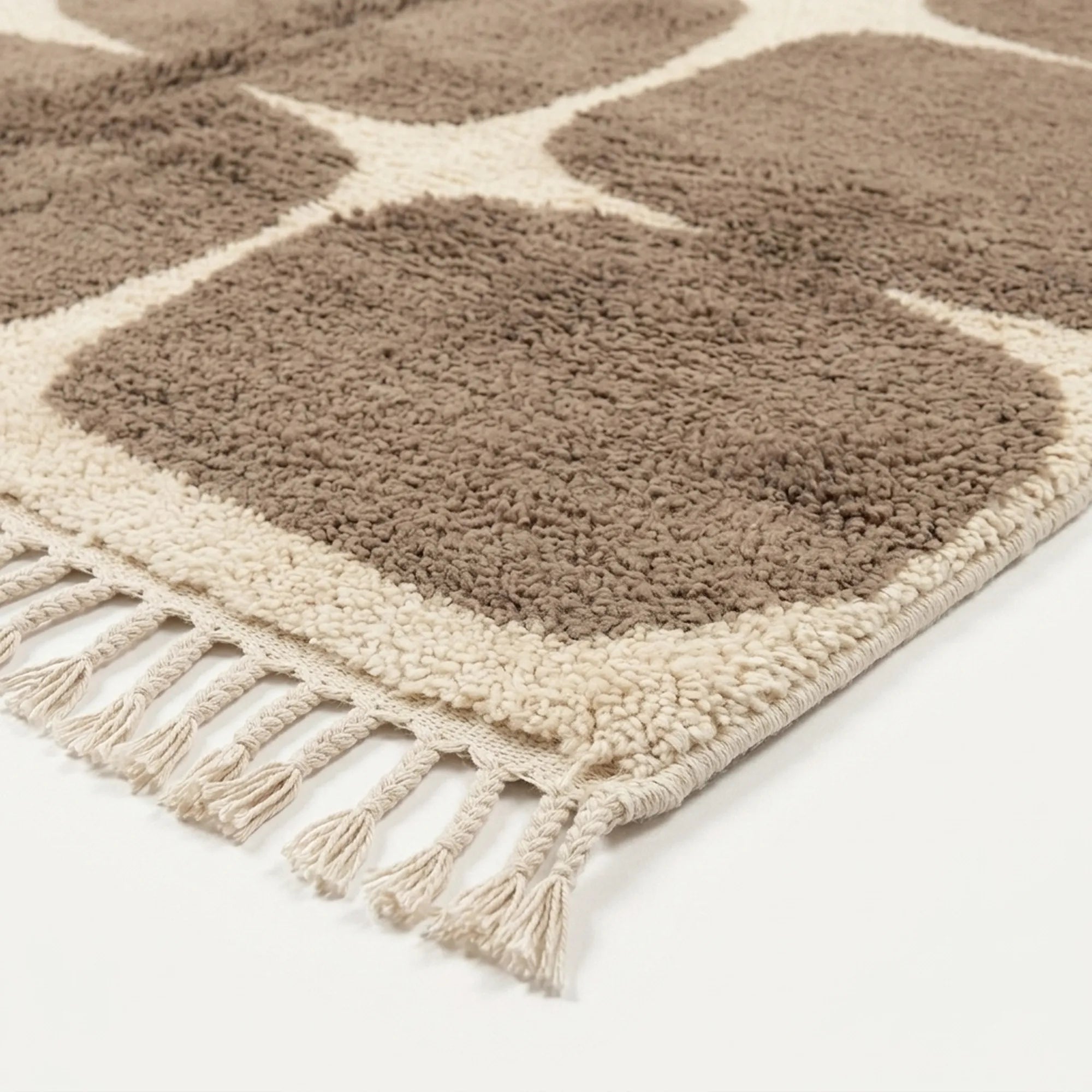 Close-up of the taupe rounded grid pattern on the Asif ivory wool rug.