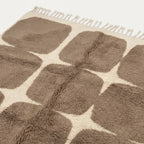 Angled view of the Asif taupe and ivory hand-knotted Beni Ourain rug.