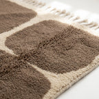 Pattern detail of the Asif taupe and ivory rounded grid Beni Ourain rug.