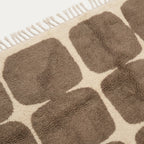 Close-up of the natural Atlas wool texture on the Asif taupe and ivory rug.