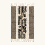 Full view of the Imal taupe, ivory and black Beni Ourain rug with a central stripe design.