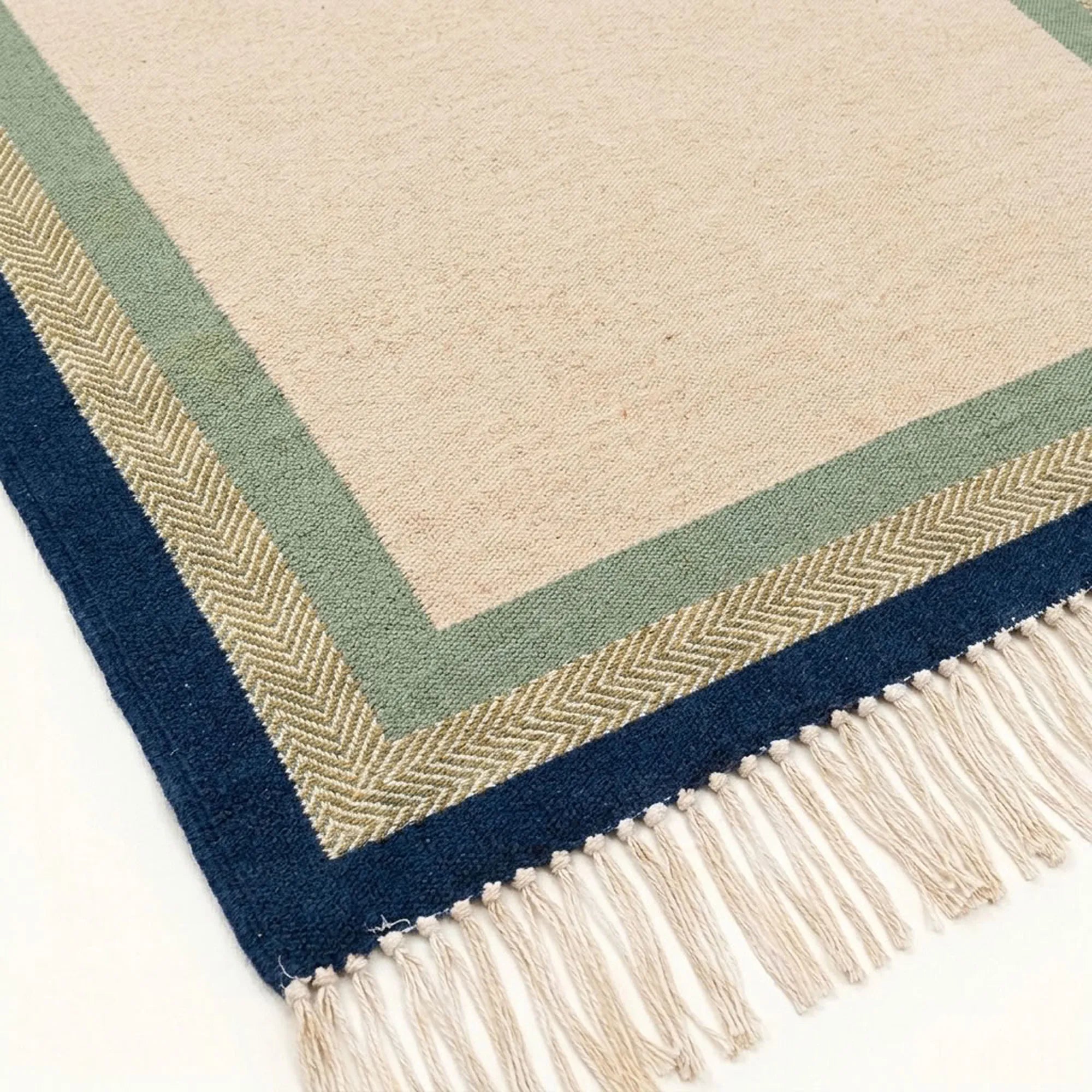 Ivory, sage and navy Zanafi rug Tazalt with layered border design, weave and fringe detail