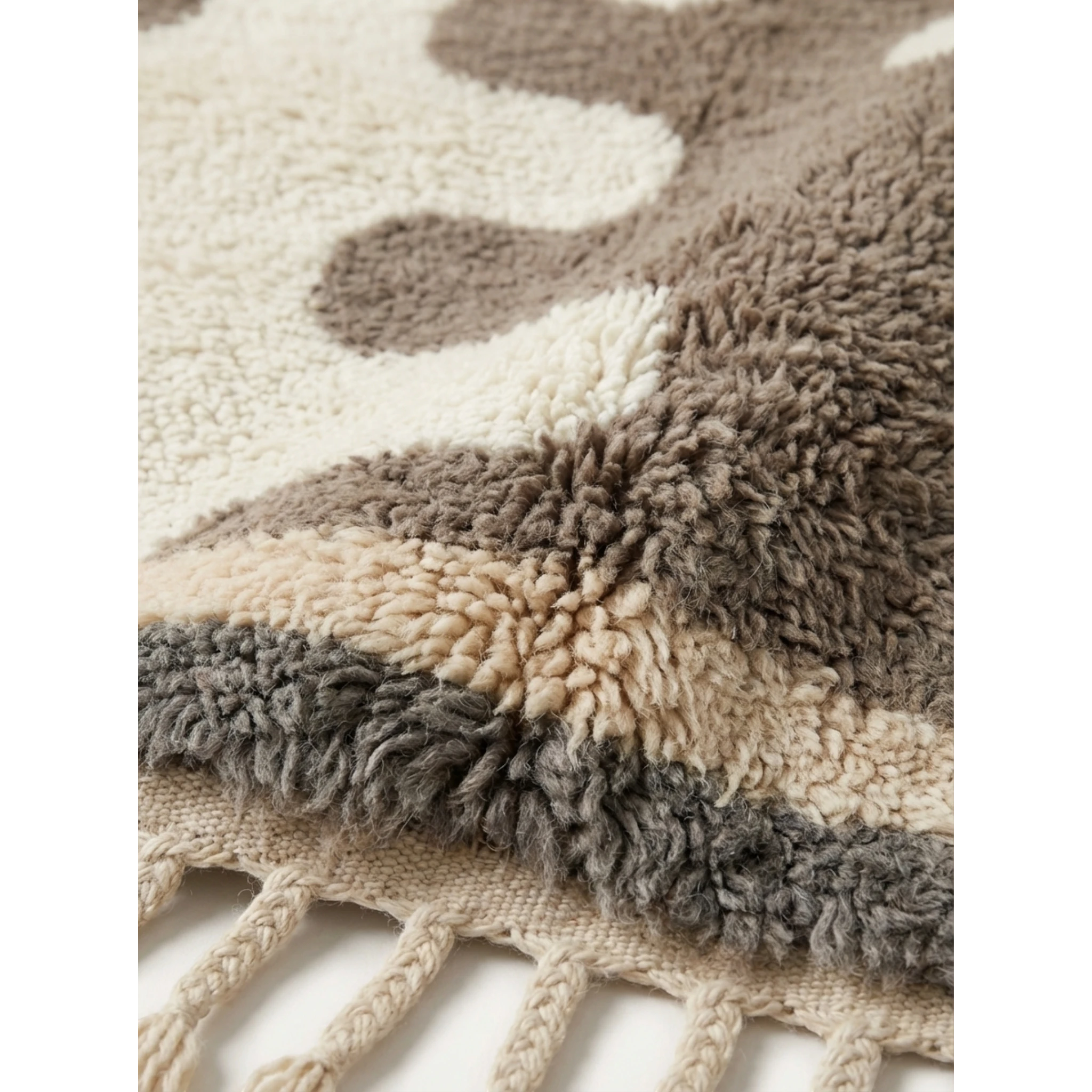 Fringe corner of the Tazrout taupe and ivory Beni Ourain rug showing its thick hand-knotted pile.