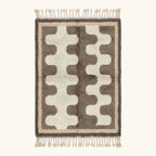 Full view of the Tazrout Beni Ourain rug with taupe abstract forms on an ivory ground and hand-tied fringe.