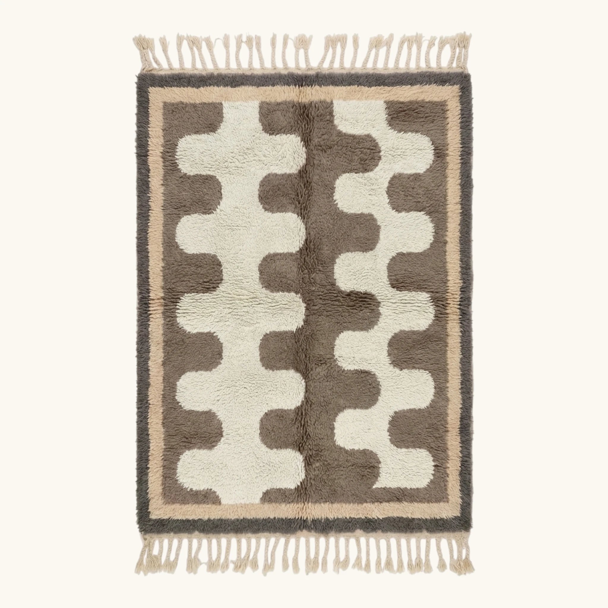 Full view of the Tazrout Beni Ourain rug with taupe abstract forms on an ivory ground and hand-tied fringe.