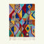 Full view of the Tifawt teal, blue and saffron Boujaad rug with a geometric patchwork diamond design.
