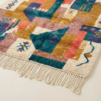 Lower-edge and fringe detail of the Tazmara Boujaad rug with teal, blush, ochre and cream blocks