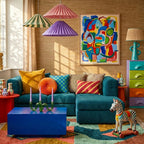 Tifawin Boujaad rug styled in a colorful room with its teal, coral and ochre abstract geometry visible
