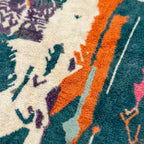 Pattern close-up of Tafraout showing cream abstract forms, orange vertical bands, teal fields and purple woven marks