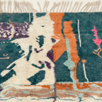 Close-up of the Tafraout Boujaad rug showing plush teal, cream and orange hand-knotted wool