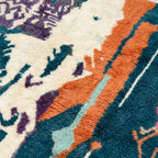 Edge detail of Tafraout showing cream, orange and teal abstract woven fields