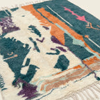 Fringe and lower-edge detail of the Tafraout Boujaad rug with teal, cream and orange abstract motifs