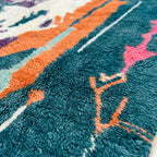 Detailed view of Tafraout showing painterly cream shapes, orange bands and small colorful woven symbols