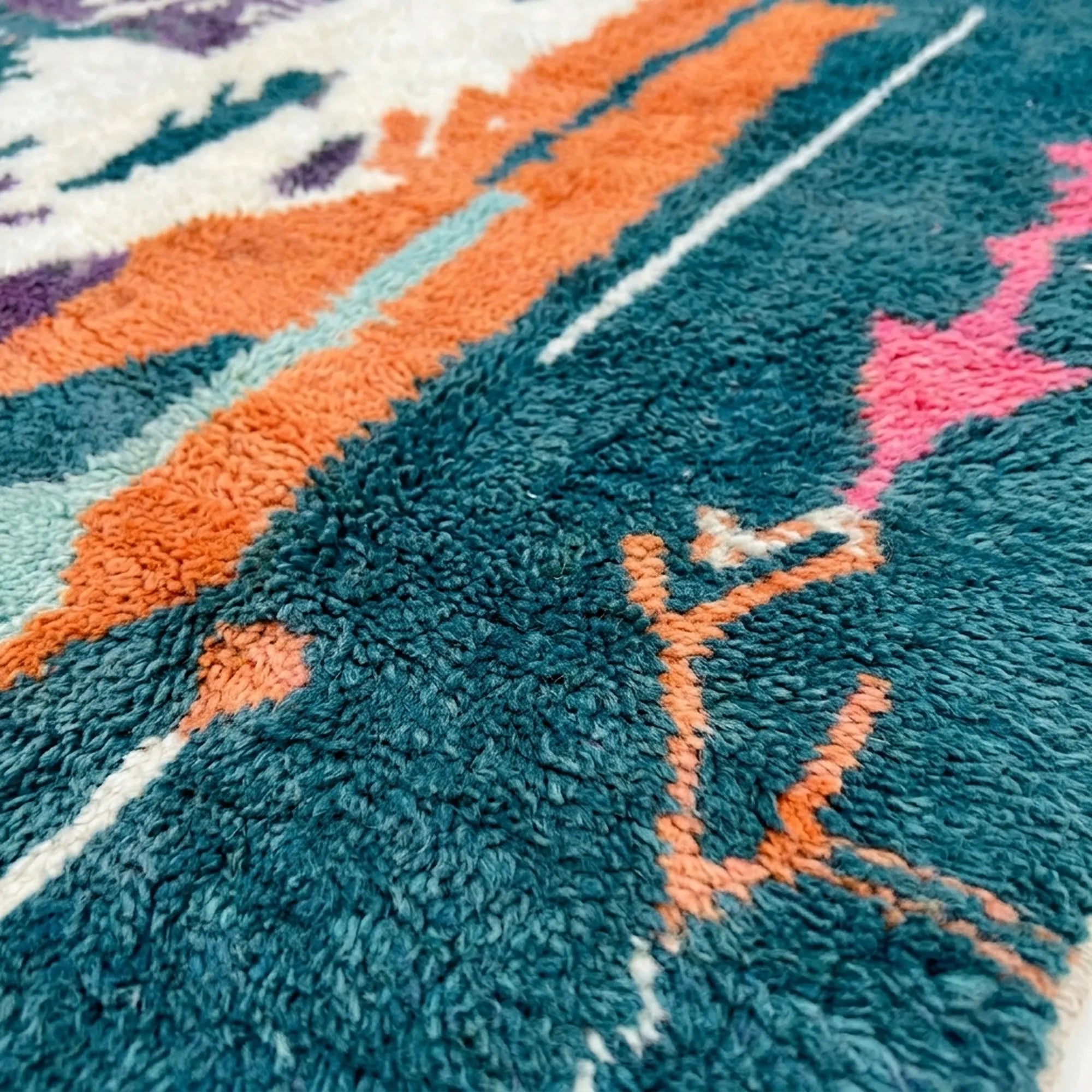 Detailed view of Tafraout showing painterly cream shapes, orange bands and small colorful woven symbols
