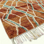Terracotta and aqua Mrirt rug Amsaw edge and wool texture detail