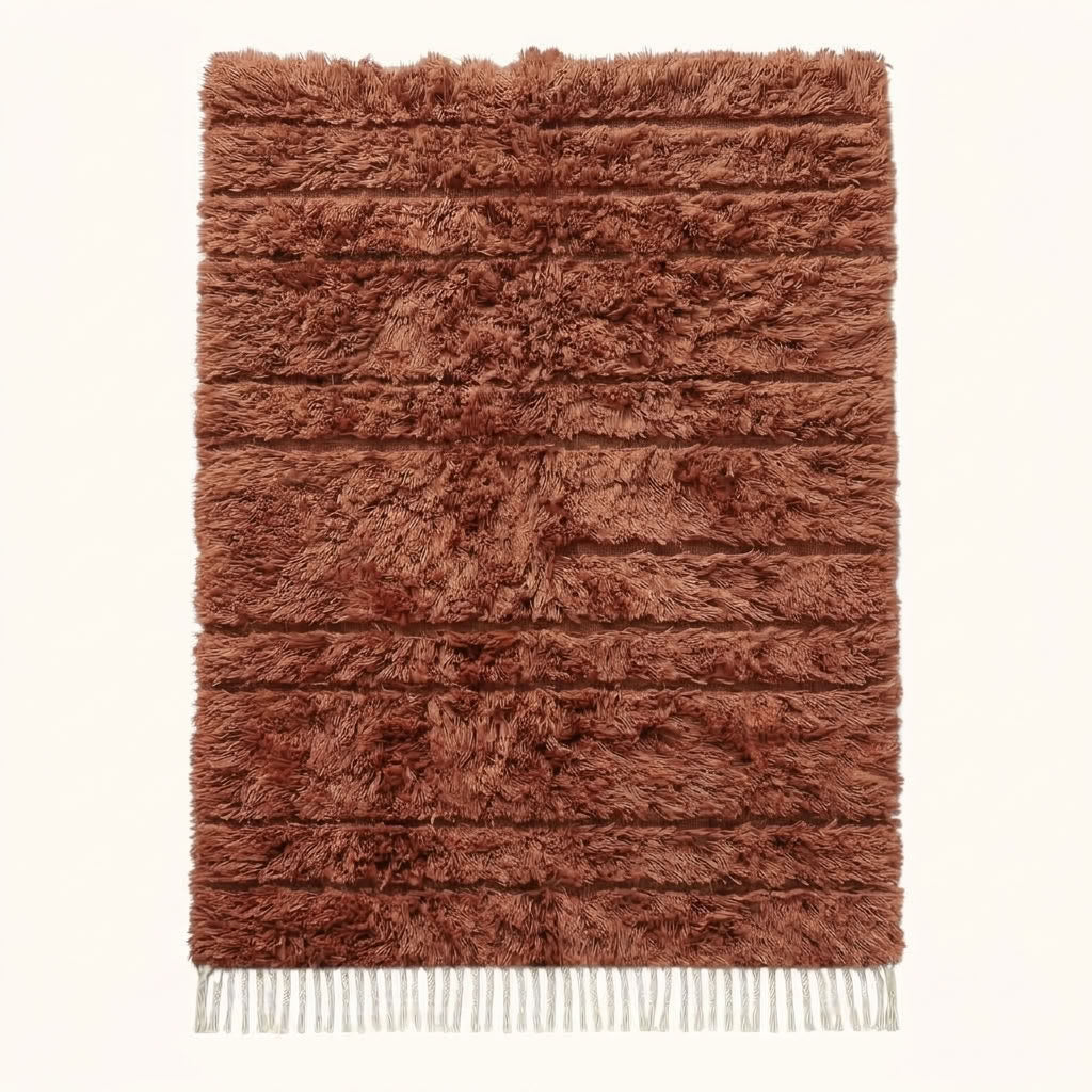 Terracotta and ivory Beni Ourain rug Assif with horizontal textured stripes, flat lay on plain background