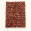 Terracotta and ivory Beni Ourain rug Assif with horizontal textured stripes, flat lay on plain background