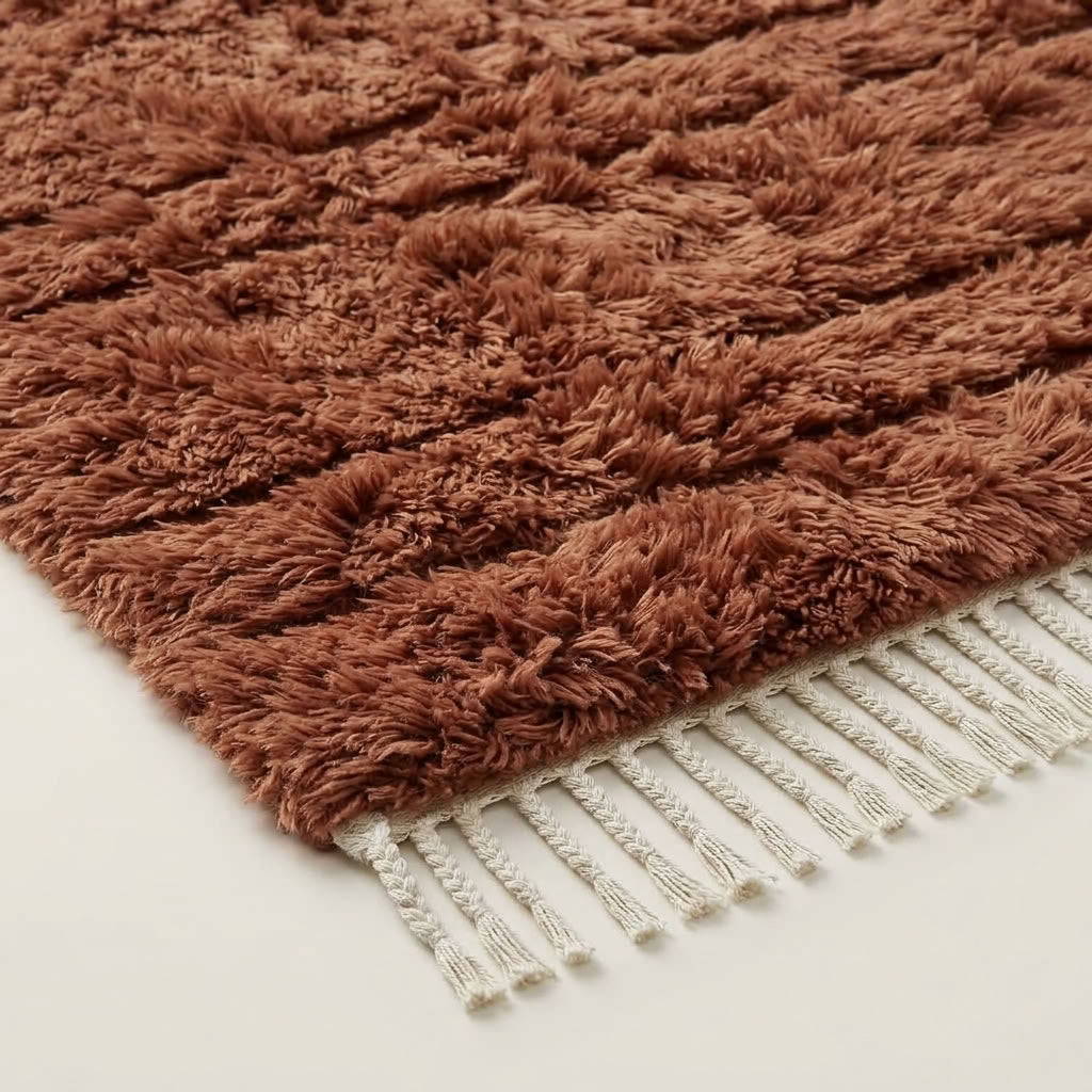 Close-up texture of terracotta Beni Ourain wool pile with organic band variation