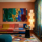Ilyan Boujaad rug styled in a living room with its terracotta, blush and teal abstract design visible