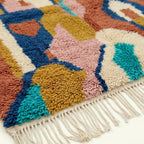 Close-up of the plush hand-knotted wool texture and color transitions on the Ilyan Boujaad rug