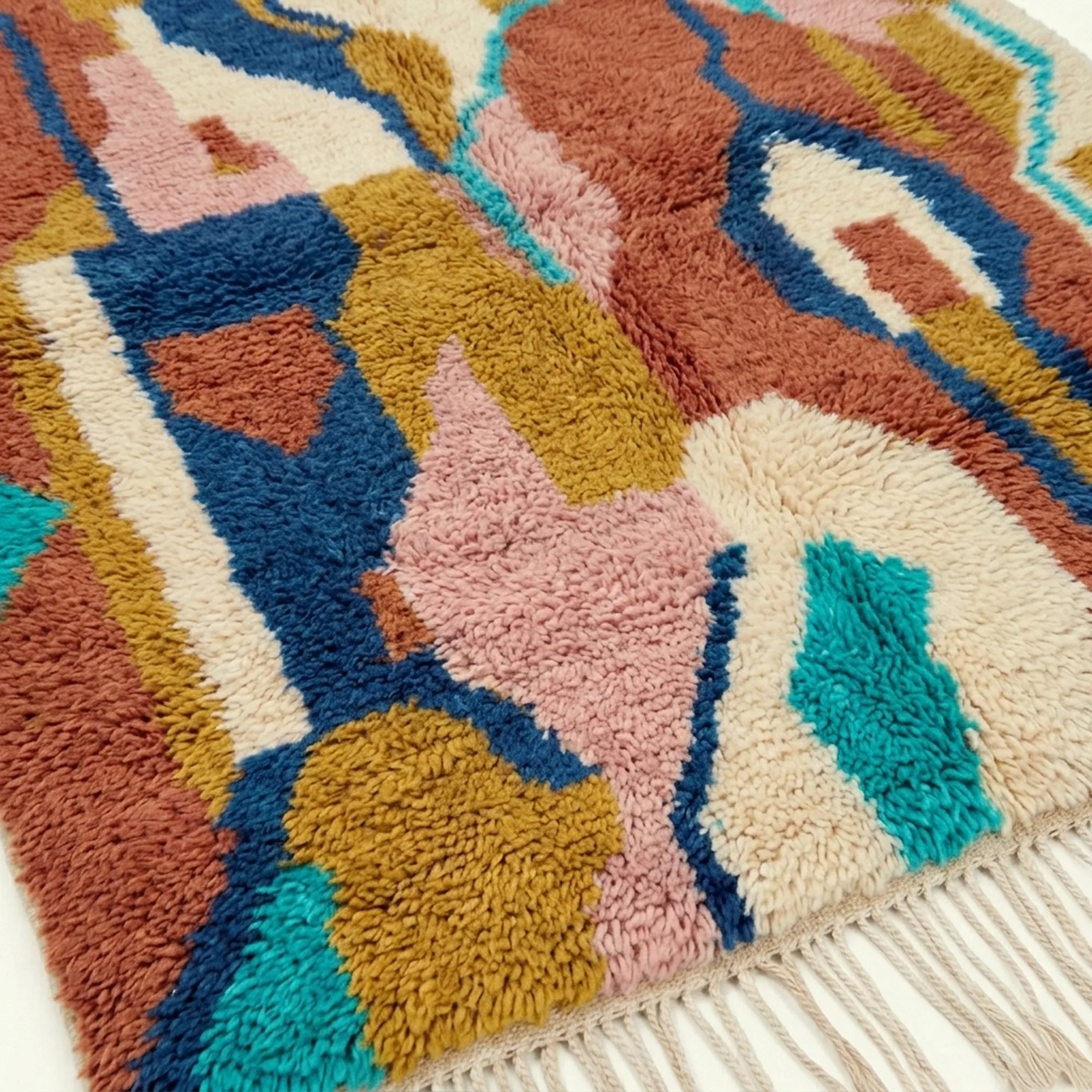 Pattern close-up of Ilyan showing abstract vertical forms outlined in navy, teal and cream