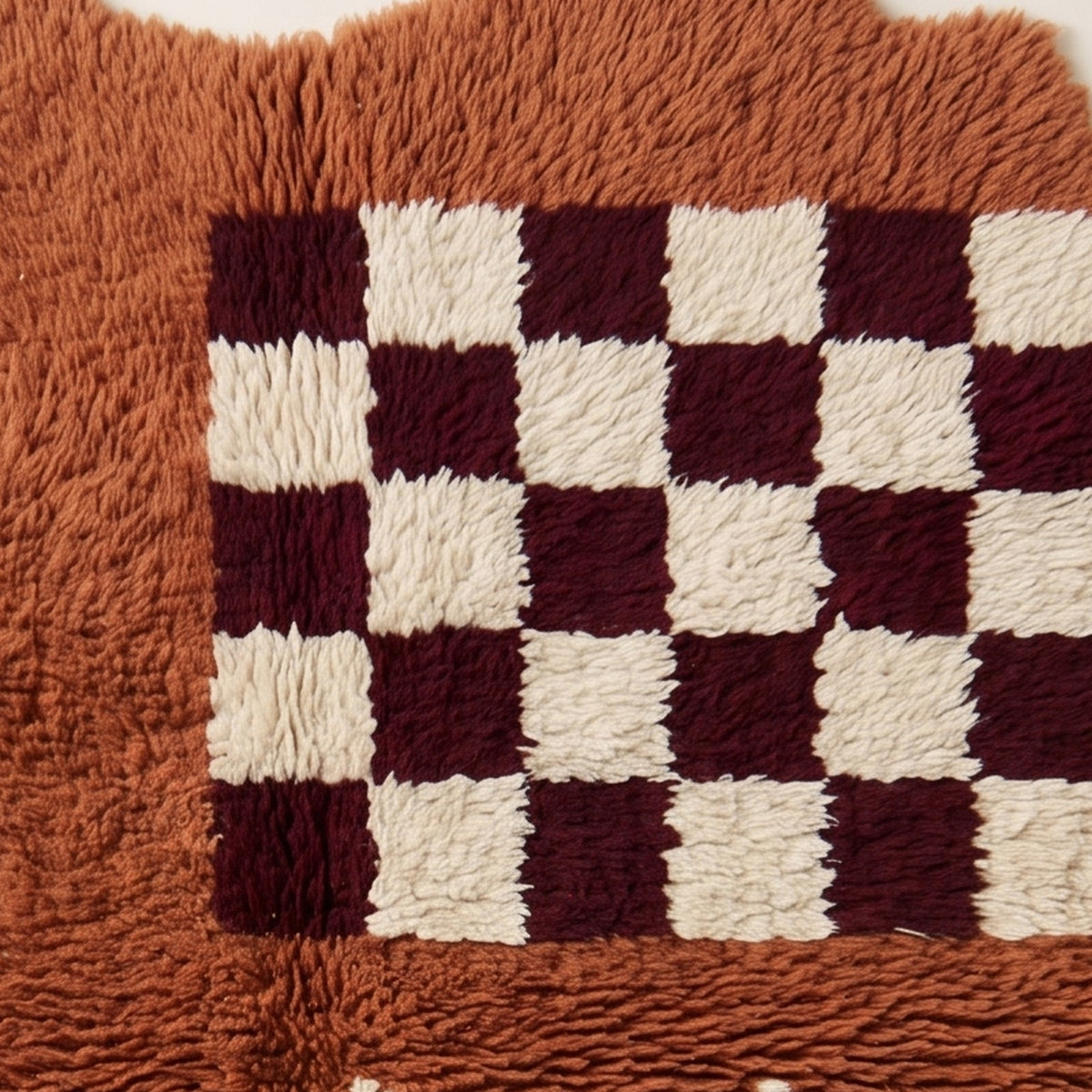 Detailed view of checkerboard pattern and zigzag band showing individual knotted wool construction