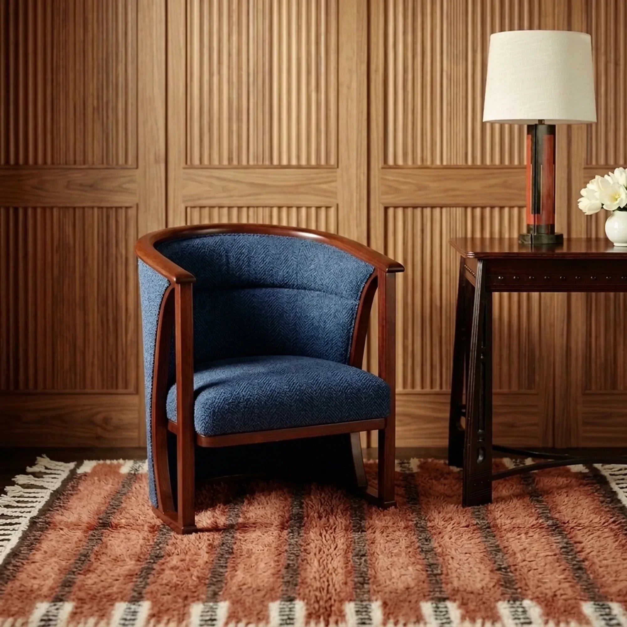 Tiziri terracotta, charcoal and ivory Beni Ourain rug styled in a refined living room.