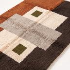 Close-up of Tawenza patchwork grid showing plush wool pile texture and colour blocks