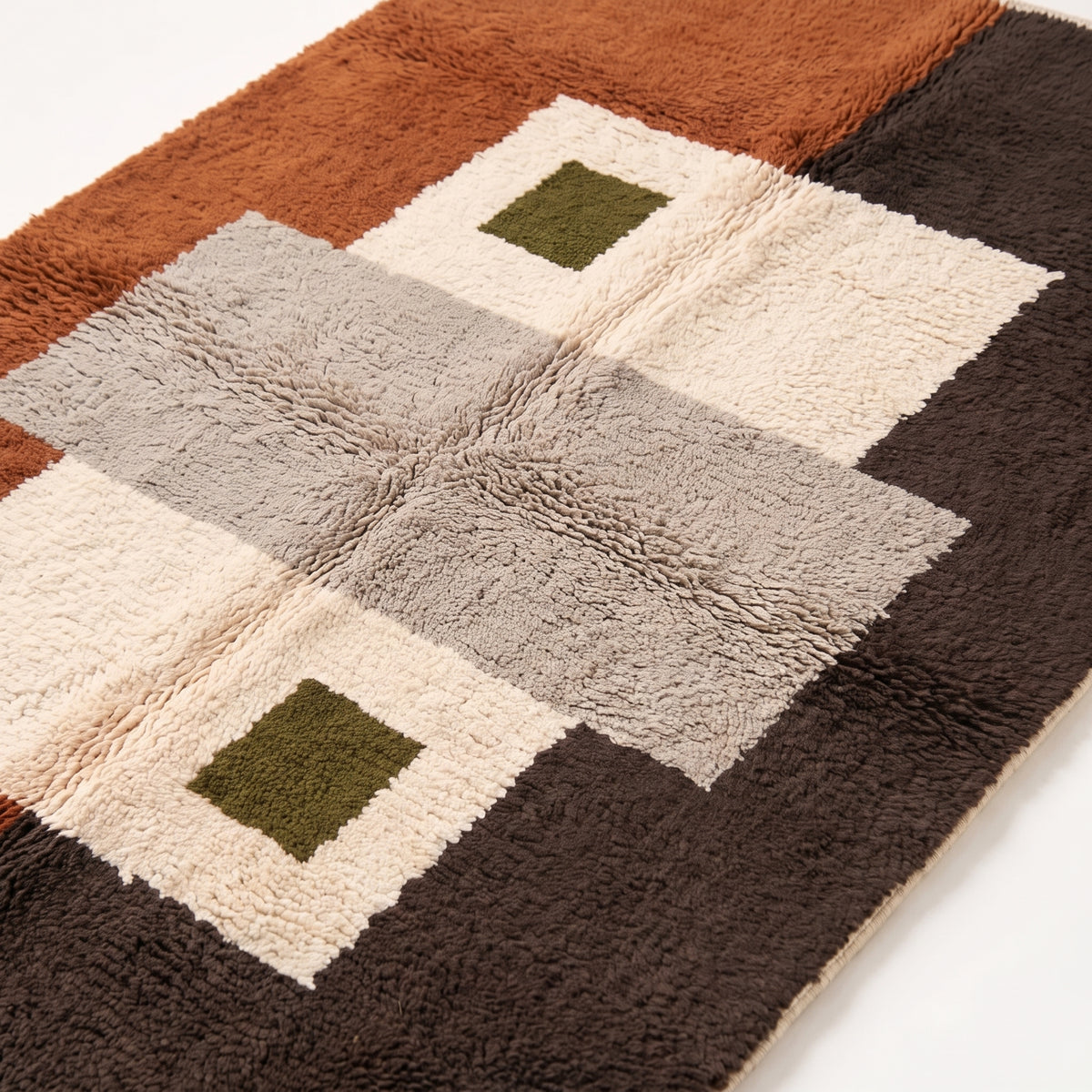 Close-up of Tawenza patchwork grid showing plush wool pile texture and colour blocks