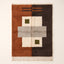 Terracotta and charcoal Mrirt rug with patchwork grid of ivory, grey and olive blocks, Tawenza, flat lay