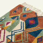 Border and edge detail of the Ayyur Boujaad rug in terracotta and cream.