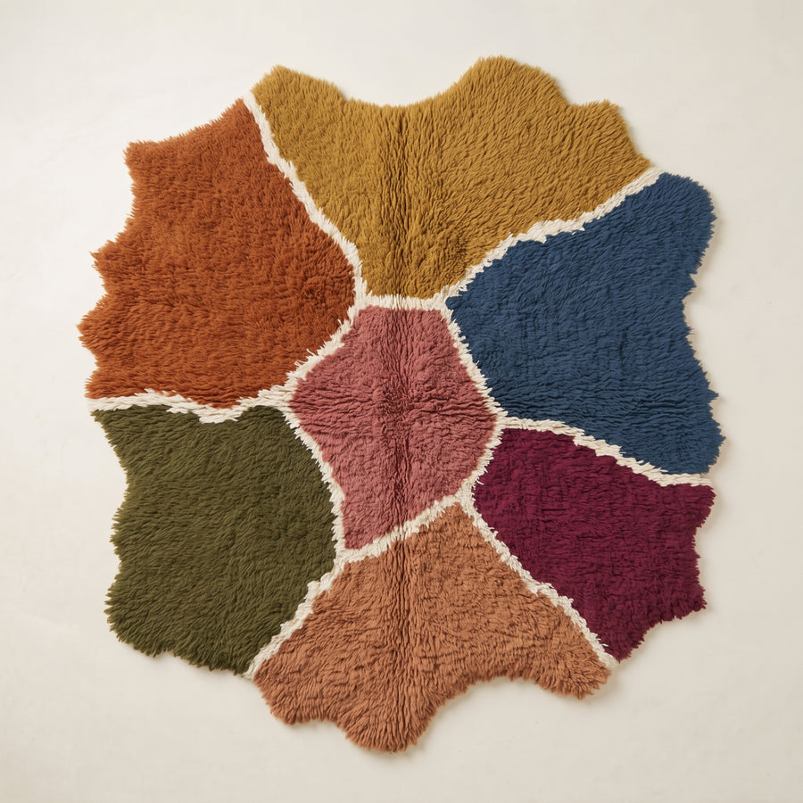 Talwit Azilal rug in terracotta, gold, navy, rose, olive and burgundy with organic colour patches separated by ivory lines, flat lay view