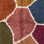 Texture close-up of Talwit showing soft wool pile and hand-drawn ivory lines separating colour blocks