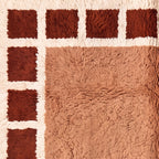 Angled detail of Tafat rug showing border squares and central field pile depth