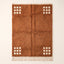 Terracotta and ivory Beni Ourain rug with cream corner grids on plain background