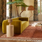 Tislit terracotta and ivory Beni Ourain rug styled in a warm contemporary living room.