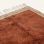 Dense natural Atlas wool pile detail of the Tislit terracotta Beni Ourain rug.