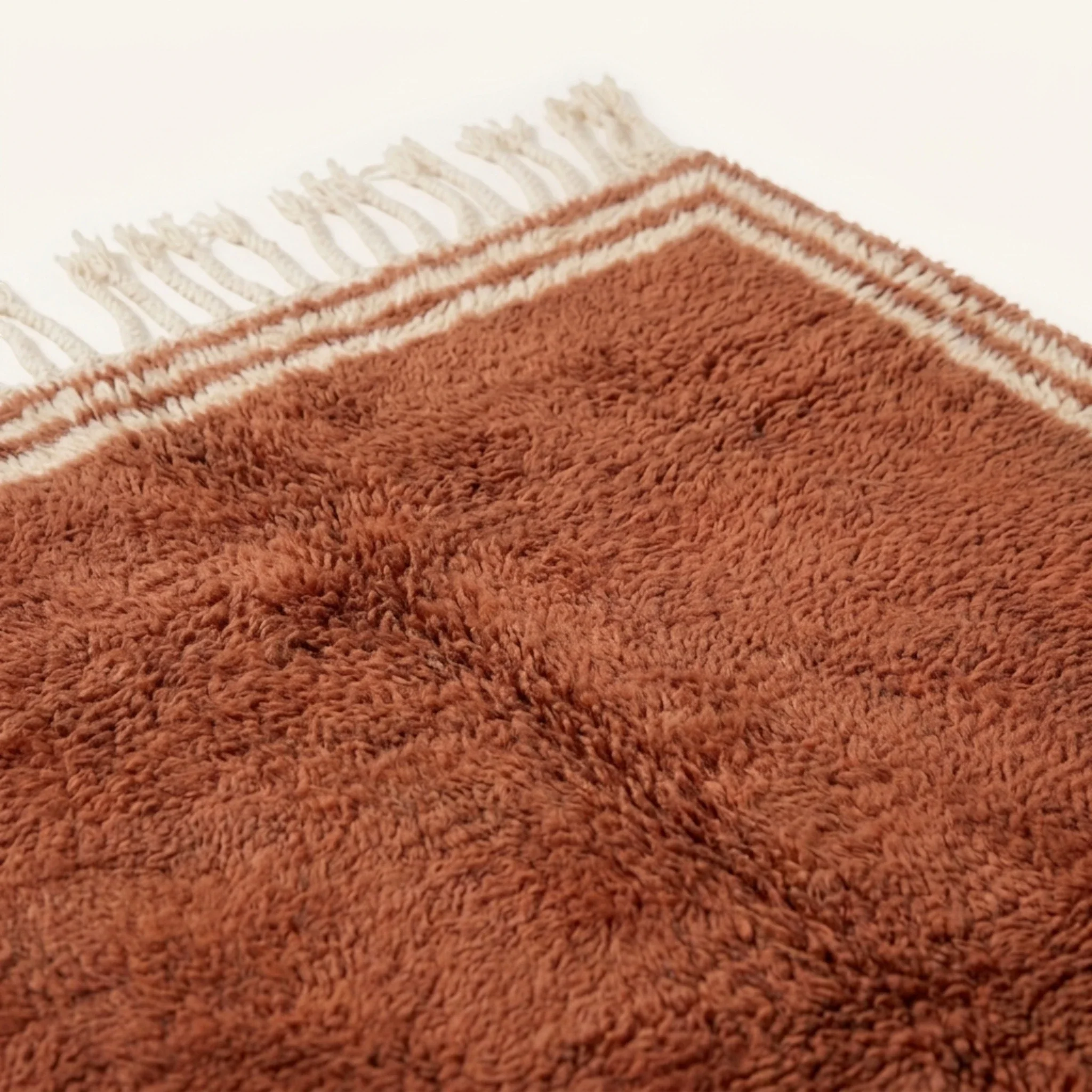 Dense natural Atlas wool pile detail of the Tislit terracotta Beni Ourain rug.